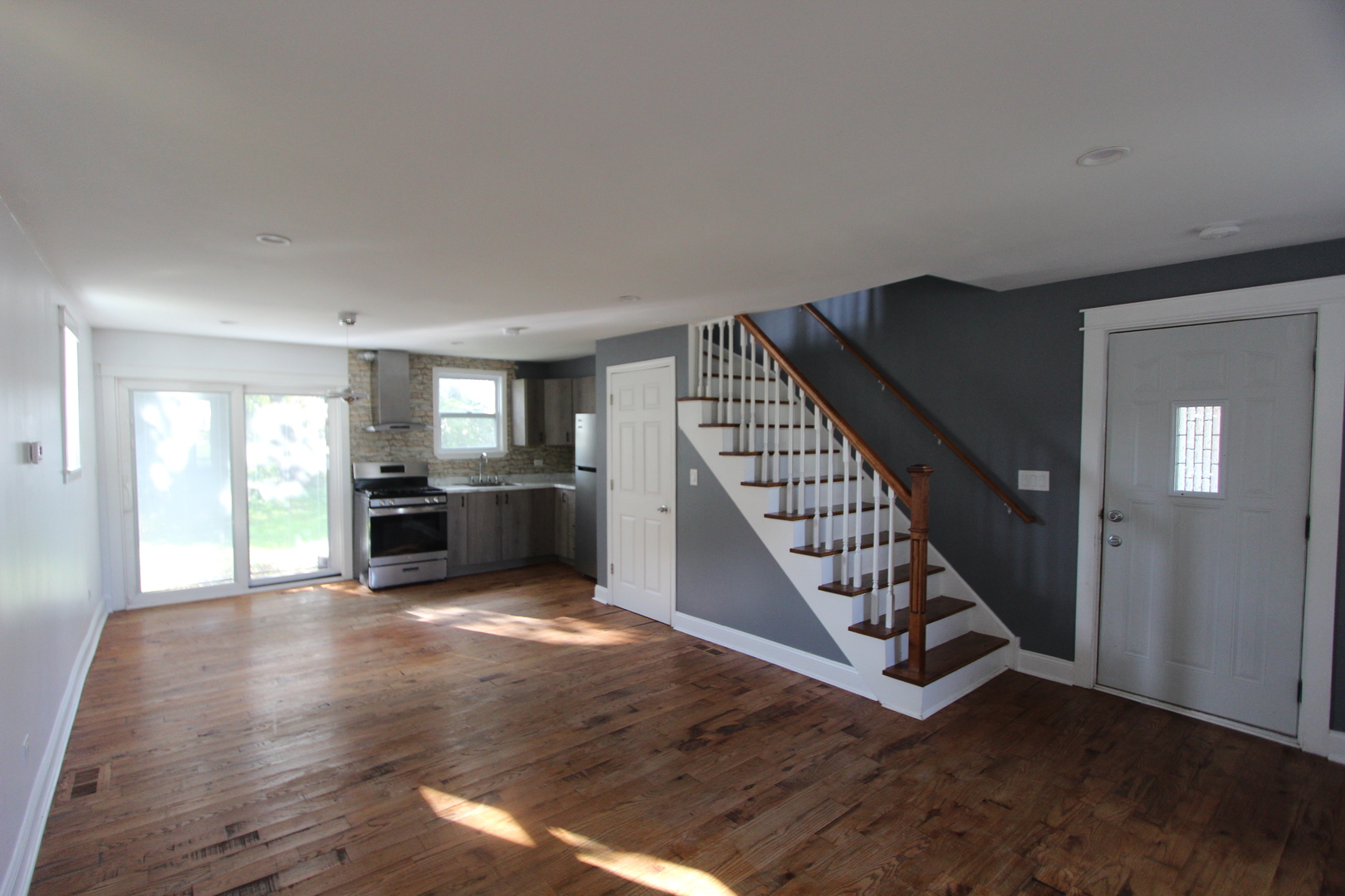 633 1/2 Whitney Boulevard Belvidere, IL 61008 - Photo 6 of 16 a view of an empty room with wooden floor and stairs