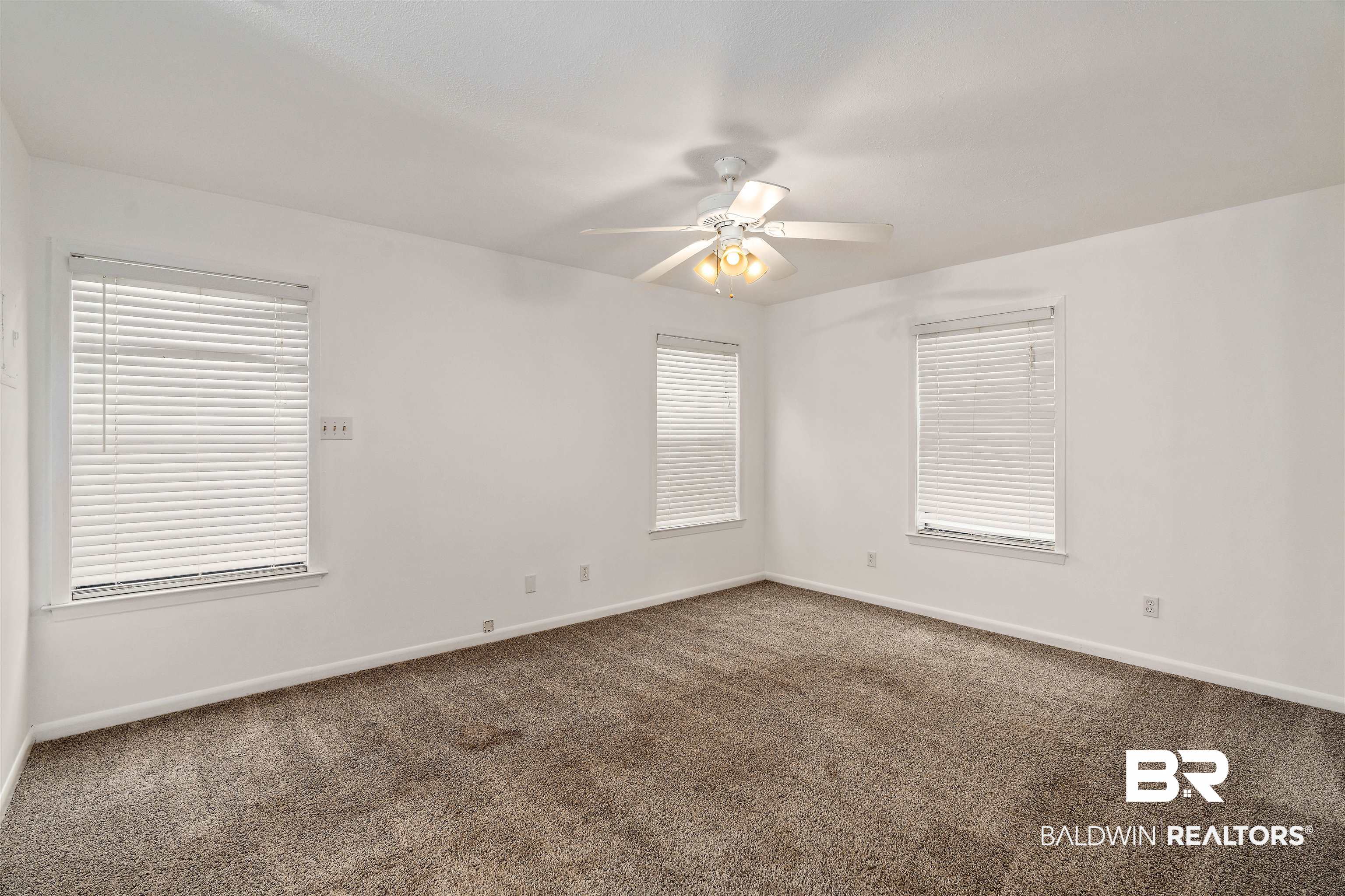 159 Montclair Loop Daphne, AL 36526 - Photo 13 of 18 Empty room with dark carpet, plenty of natural light, and ceiling fan