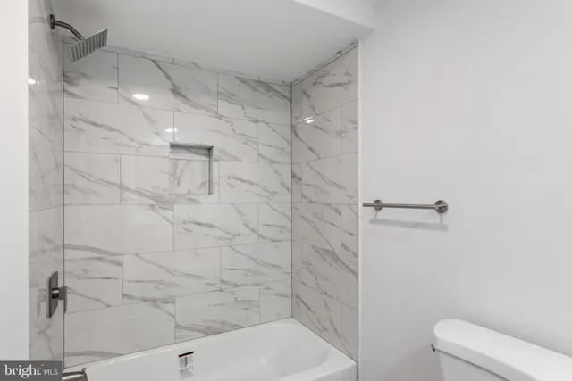 a bathroom with a shower and toilet