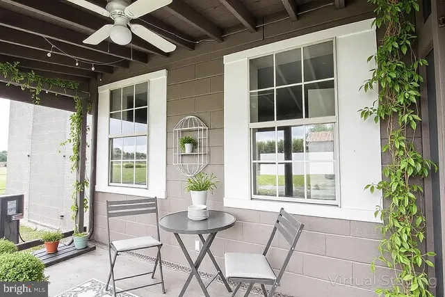 a view of house with backyard and outdoor seating