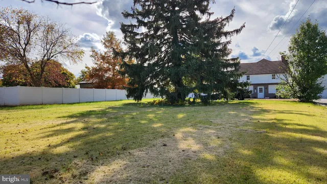 a view of yard with swimming pool and trees
