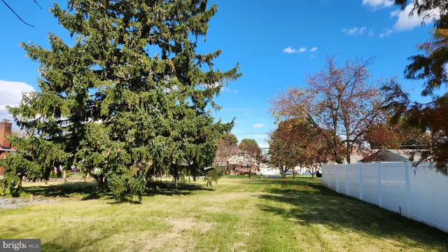 a view of yard with swimming pool and trees