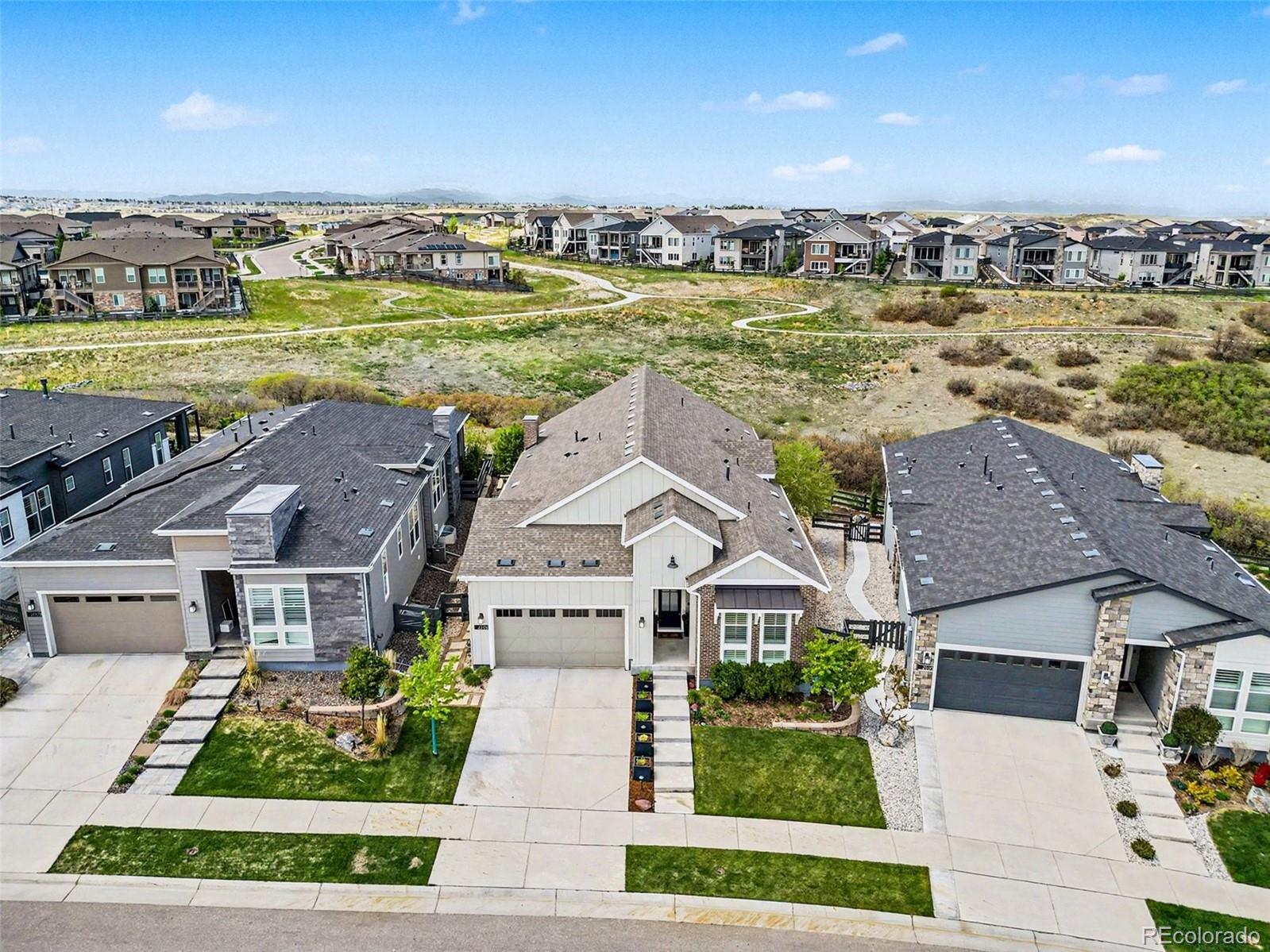 2101 Rim Ridge Drive Castle Pines, CO 80108 - Photo 36 of 50 a view of a house with a yard