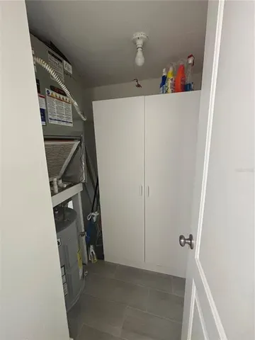 a view of patio with a table and chairs under an umbrella