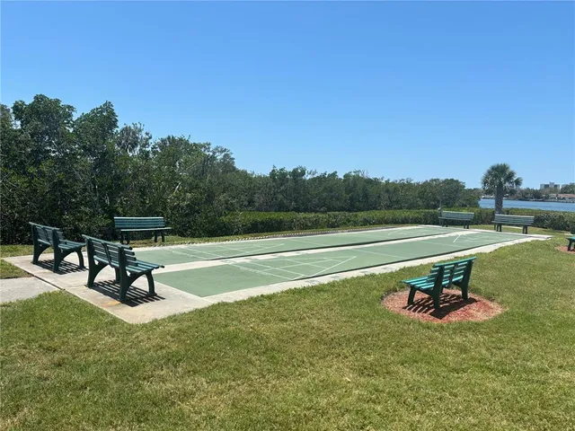 a backyard of a house with table and chairs