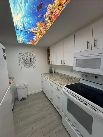 a white refrigerator freezer sitting inside of a kitchen