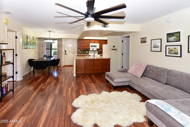 a living room with furniture and a wooden floor