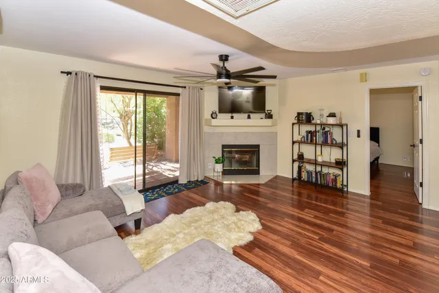 a living room with furniture fireplace and flat screen tv