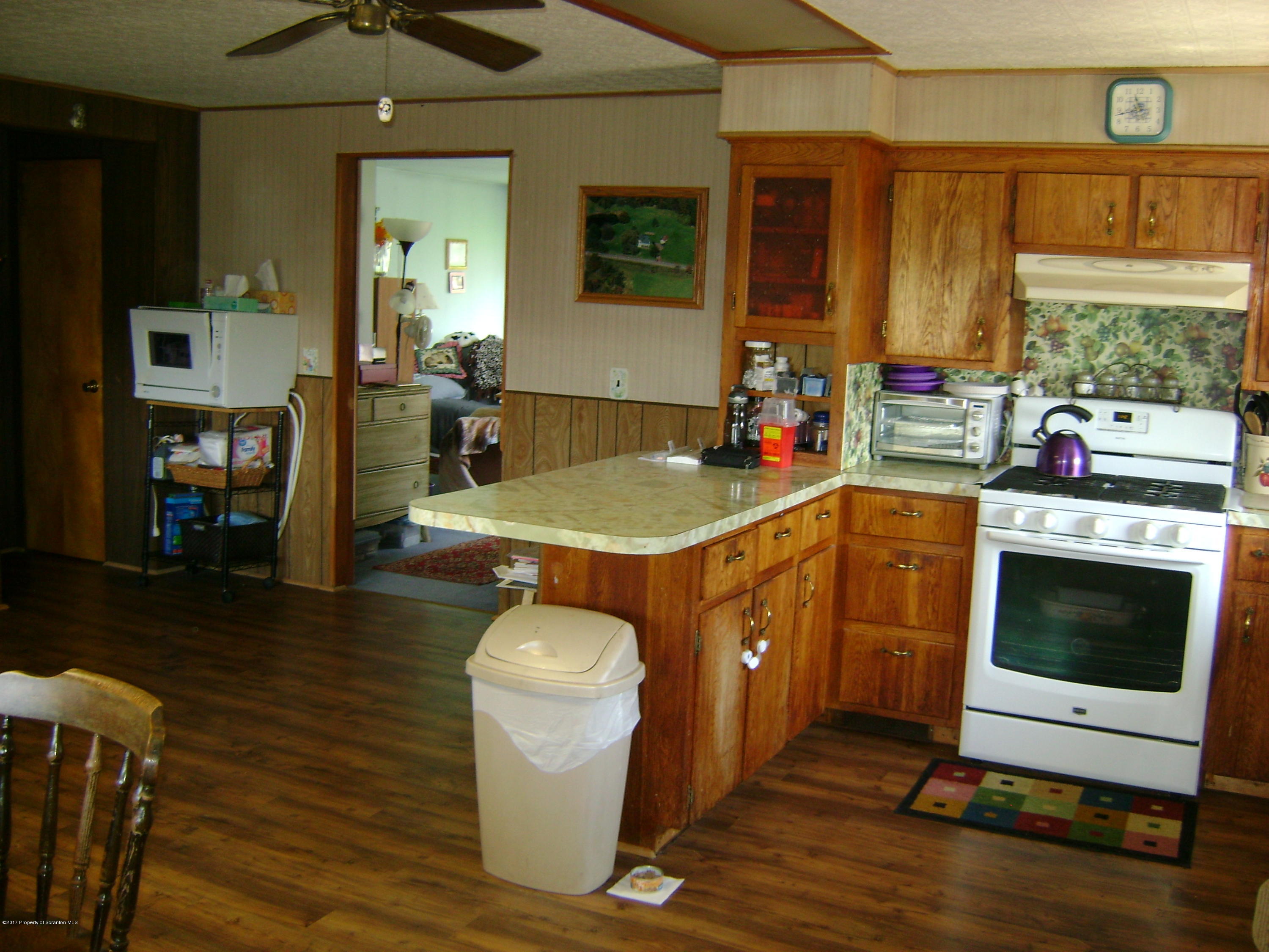 14879 Dimock To Nicholson Road Hop Bottom, PA 18824 - Photo 1 of 21 a room with a table chairs and a fireplace