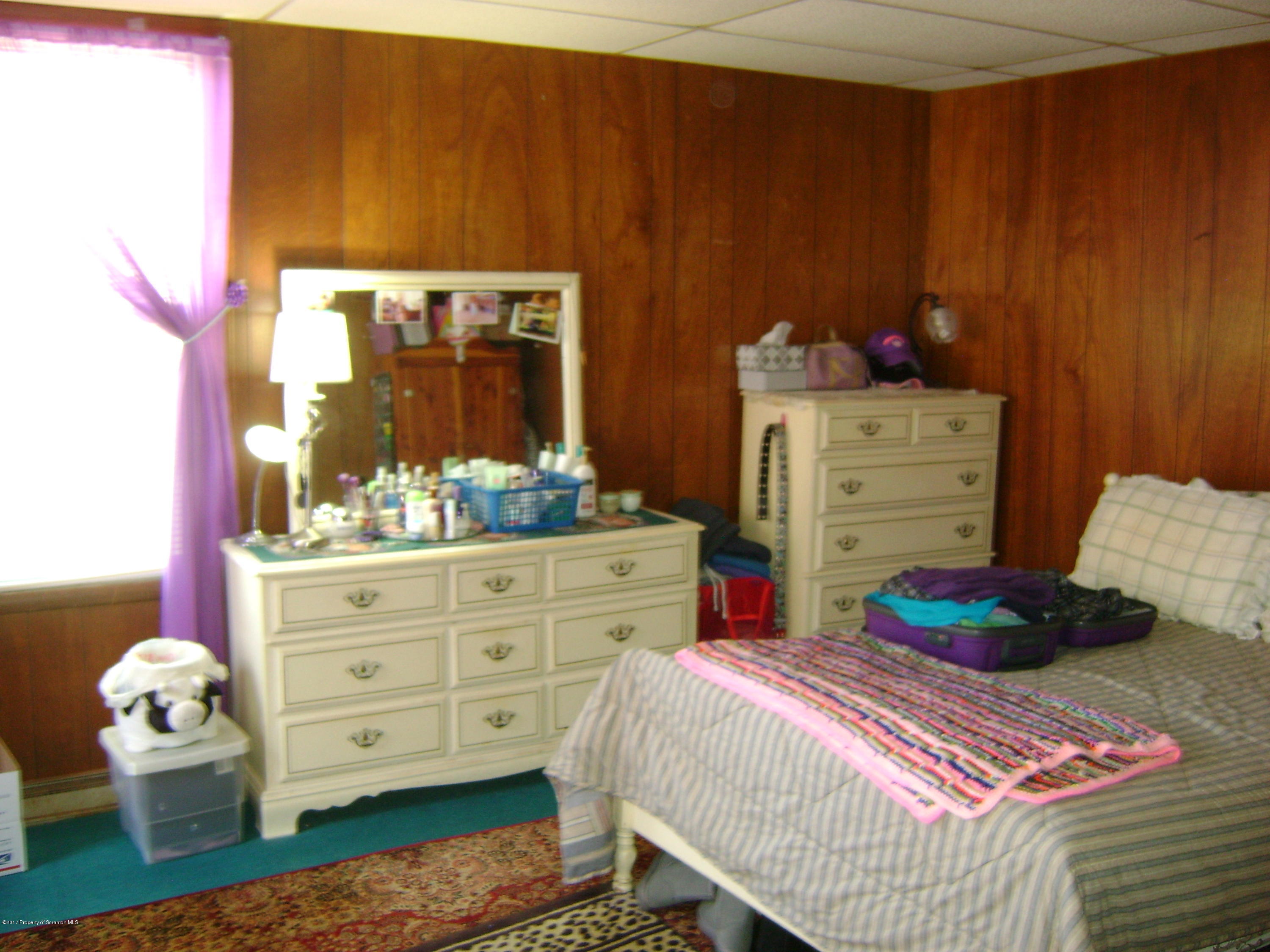 14879 Dimock To Nicholson Road Hop Bottom, PA 18824 - Photo 8 of 21 a bedroom with a bed and cabinets
