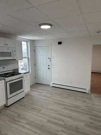 a kitchen with granite countertop a stove and a refrigerator