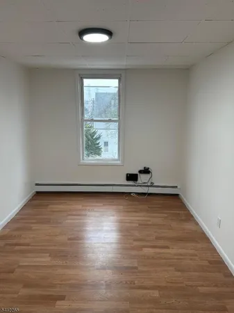a view of a room with wooden floor and window