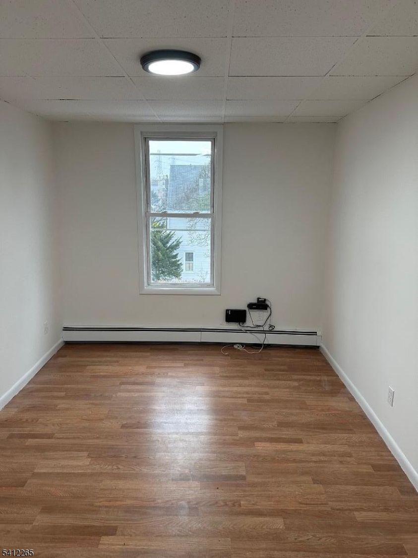 57 Harrison Street Nutley, NJ 07110 - Photo 4 of 8 a view of a room with wooden floor and window