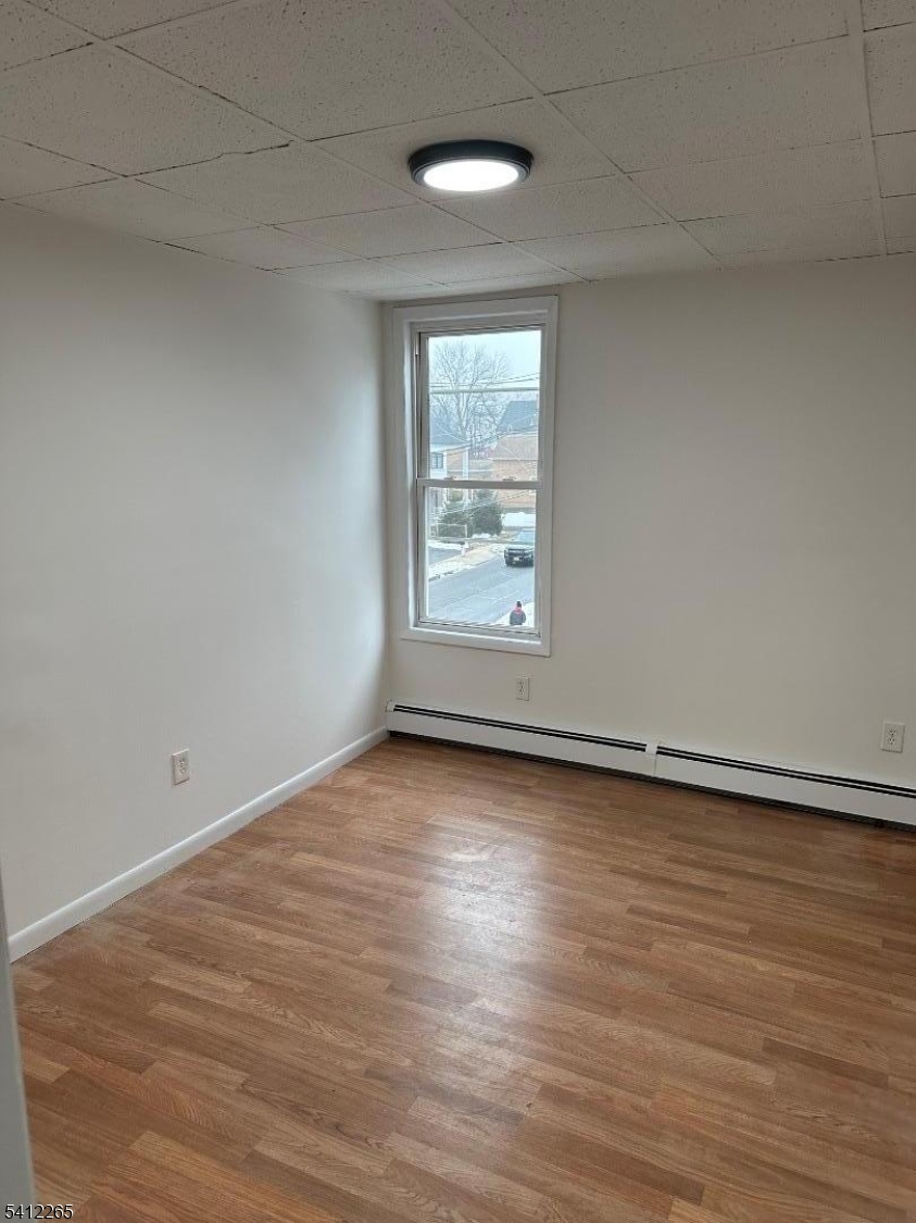 57 Harrison Street Nutley, NJ 07110 - Photo 5 of 8 wooden floor in an empty room with a window