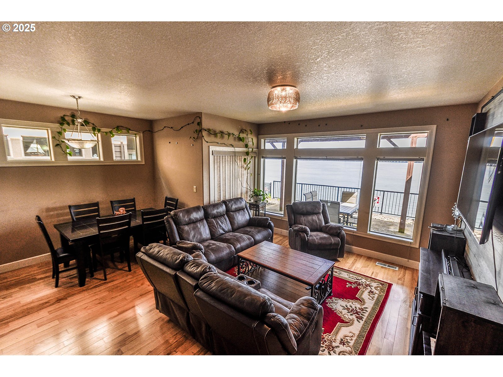 813 King Drive Rainier, OR 97048 - Photo 5 of 32 a living room with furniture a flat screen tv and a large window