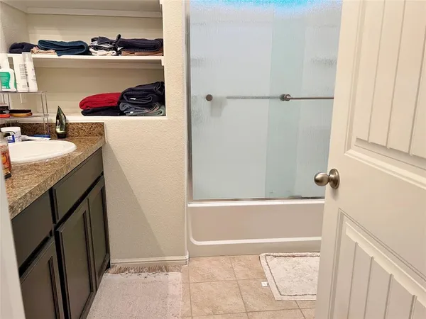 a bathroom with a tub and a sink