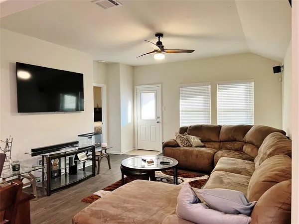 a living room with furniture and a flat screen tv