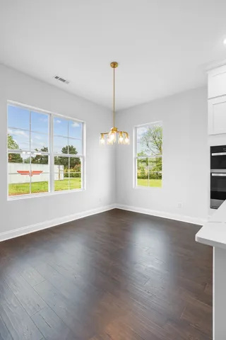 a spacious en suite bathroom with a double vanity sink a mirror and a shower