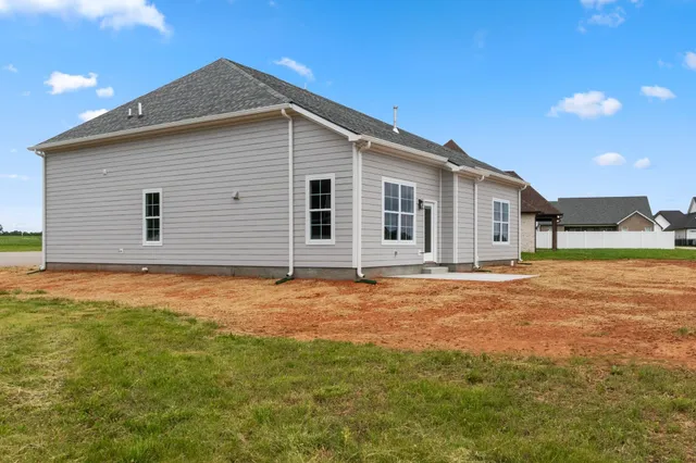 an aerial view of a house with garden space lake view and mountain view in back