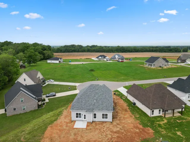 an aerial view of a house with outdoor space and lake view