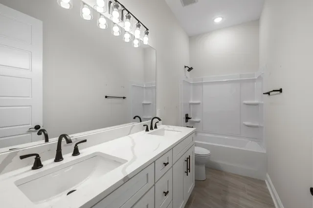 a bathroom with a sink double vanity and tub
