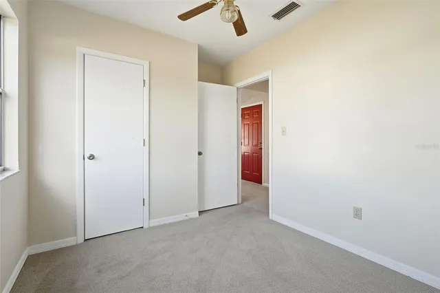 an empty room with view of ceiling fan