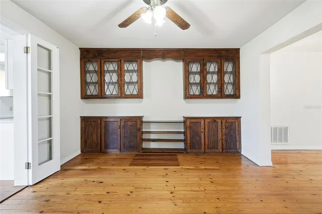 a view of room with window and wooden floor
