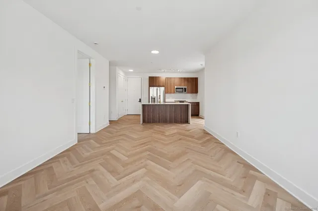 a view of kitchen with refrigerator and window