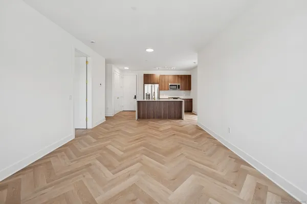 a view of kitchen with refrigerator and window