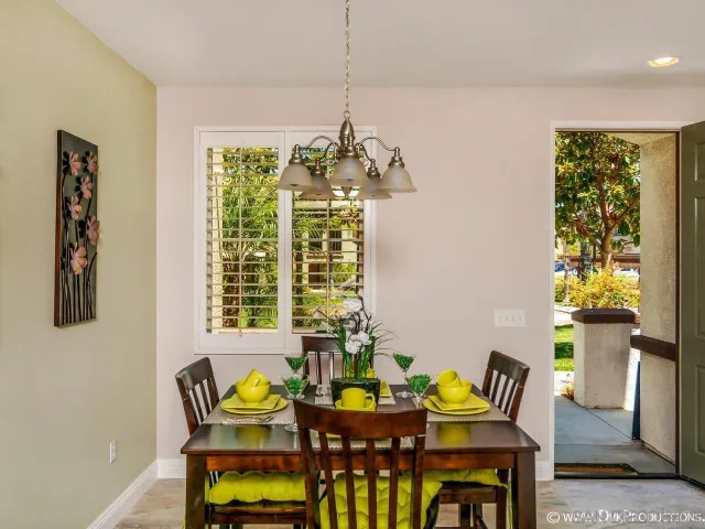 a view of a dining room with furniture and chandelier