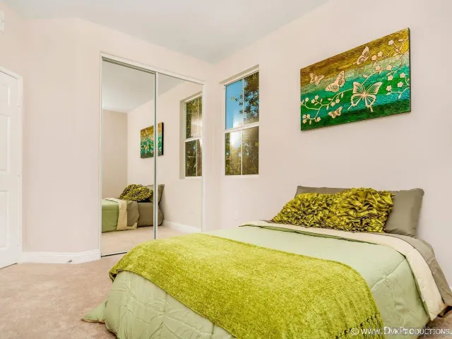 a bedroom with a bed and a flat screen tv