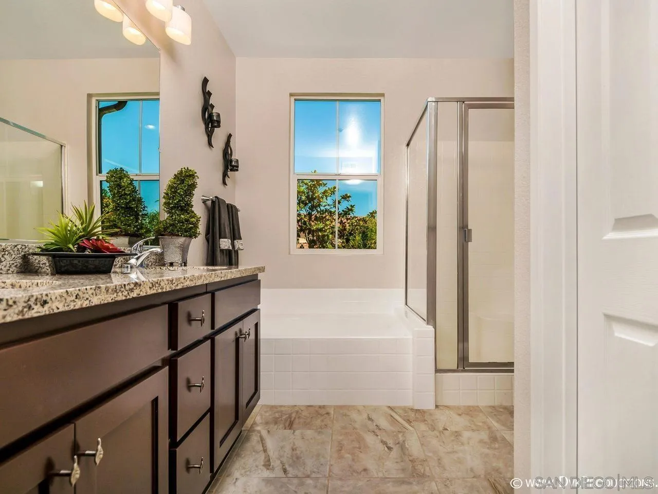 2145 Caminito Elda, Unit 104 Chula Vista, CA 91915 - Photo 8 of 9 a bathroom with a granite countertop sink and a mirror
