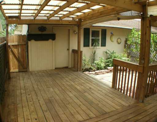 a view of a porch with wooden floor and door