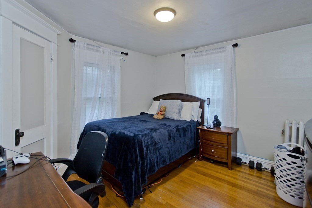 177 Belvidere Street Springfield, MA 01108 - Photo 13 of 24 a bedroom with a bed and a table in it