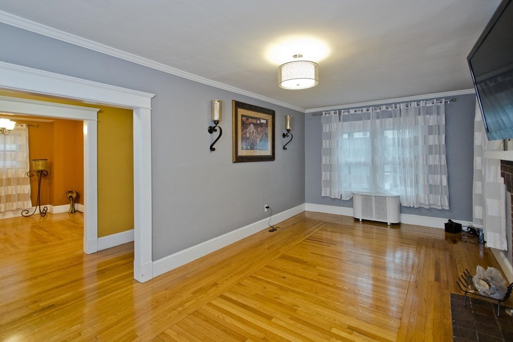 177 Belvidere Street Springfield, MA 01108 - Photo 5 of 24 a view of an empty room with window and wooden floor