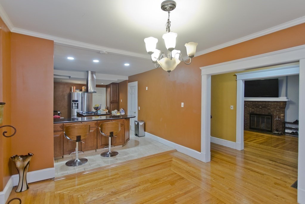 177 Belvidere Street Springfield, MA 01108 - Photo 7 of 24 a view of a kitchen with kitchen island stainless steel appliances wooden floor and living room view