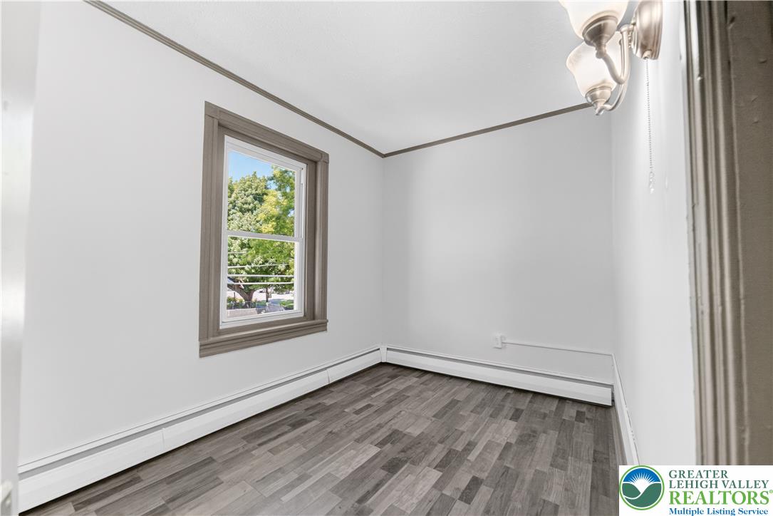 1128 Maple Street Bethlehem, PA 18018 - Photo 18 of 34 A well-lit room offers durable flooring and a street-facing window, providing a refreshing view.