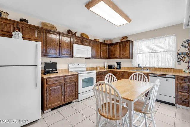 a kitchen with stainless steel appliances granite countertop a stove a sink dishwasher and a refrigerator