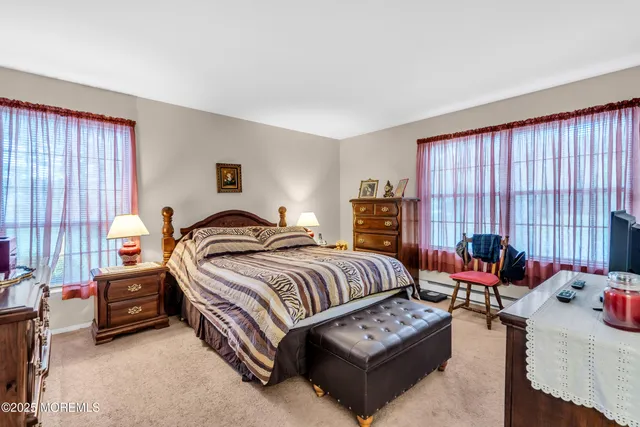 a spacious bedroom with a bed and a couch