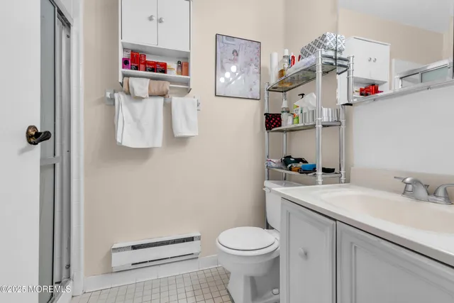 a bathroom with a sink vanity mirror and toilet