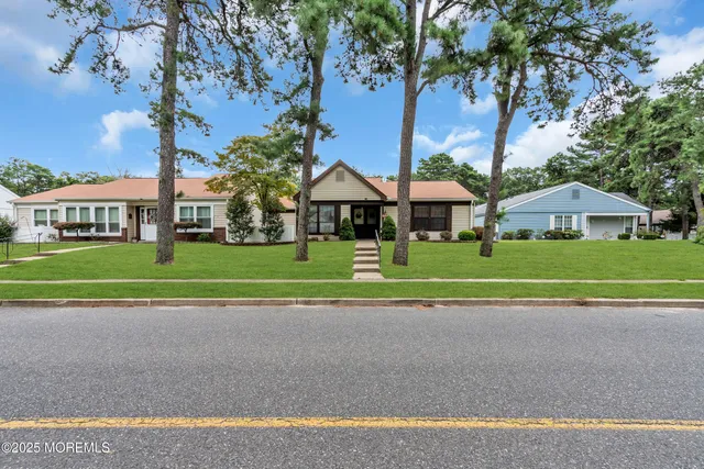 a view of street with houses and trees in the background