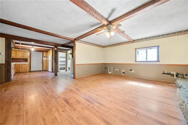 a view of a room with wooden floor and windows