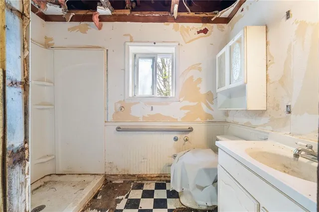 a living room with lots of furniture a rug and a window