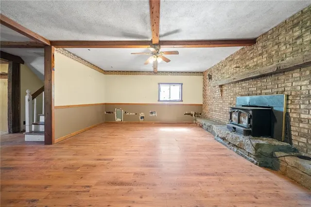a view of an empty room and a fireplace