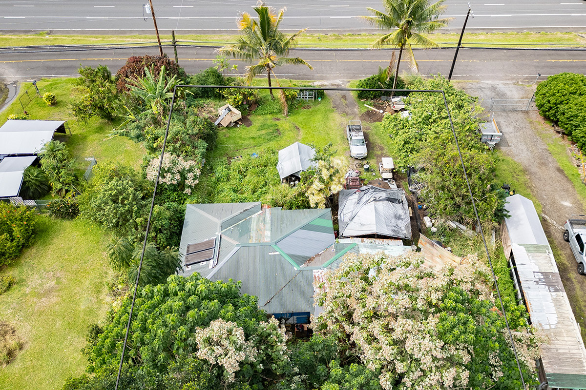 16-393 Old Volcano Road Keaau, HI 96749 - Photo 4 of 5 a view of a garden with lawn chairs under an umbrella