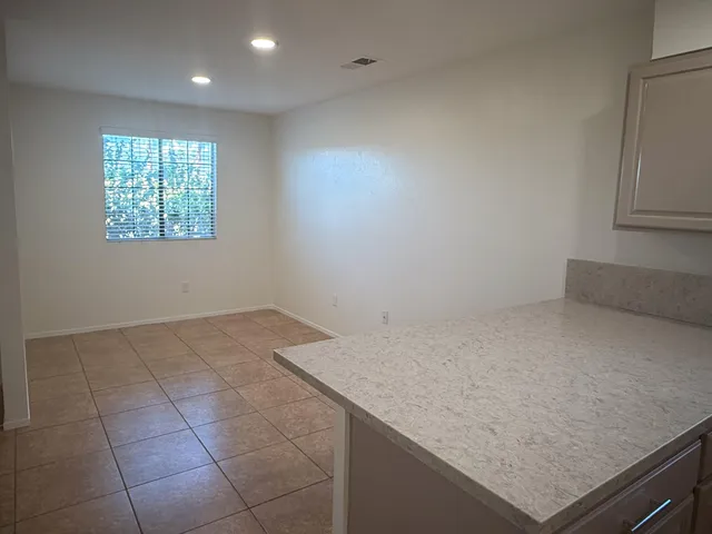 an empty room with kitchen