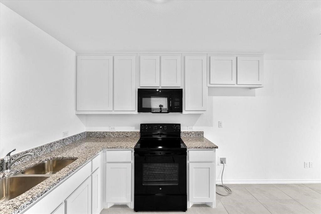 211 Herman Lane Princeton, TX 75407 - Photo 11 of 40 a kitchen with a sink and cabinets
