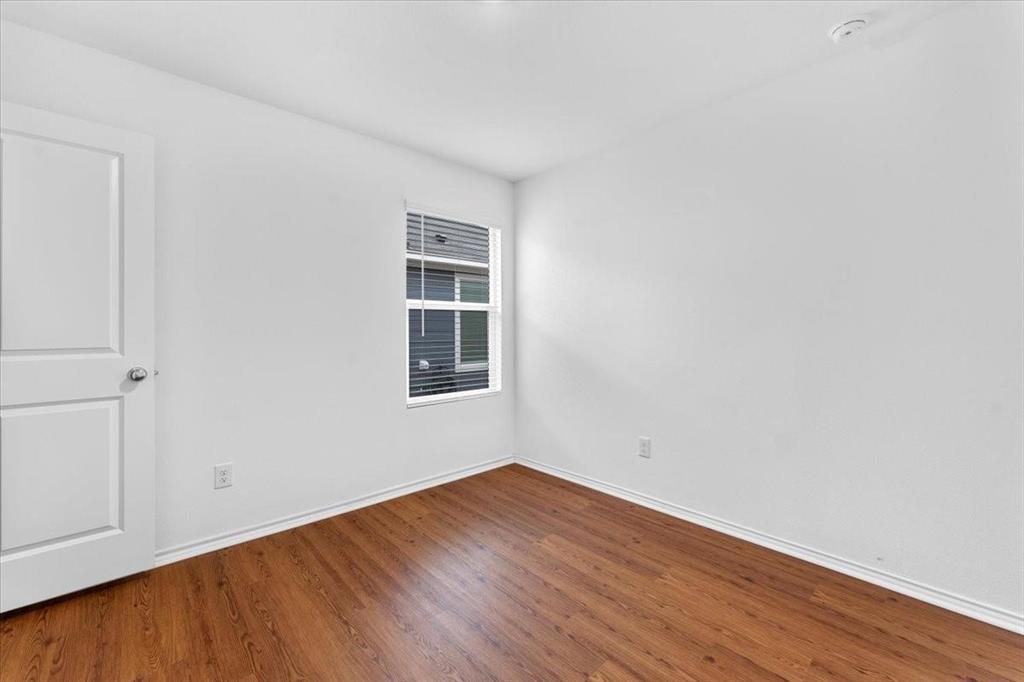 211 Herman Lane Princeton, TX 75407 - Photo 15 of 40 a view of empty room with wooden floor and fan