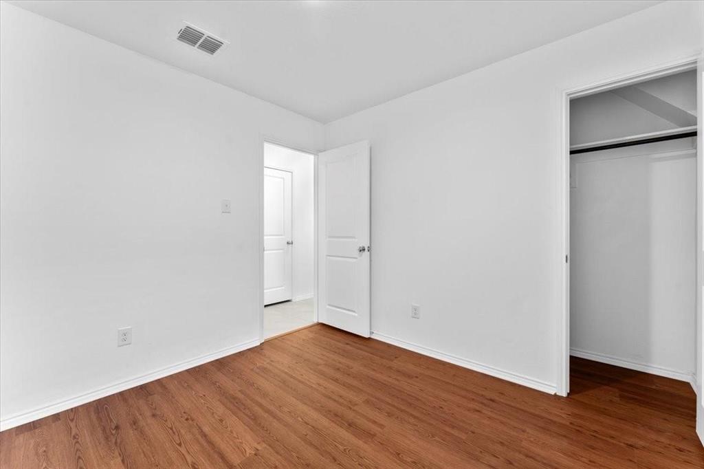 211 Herman Lane Princeton, TX 75407 - Photo 17 of 40 a view of an empty room with wooden floor