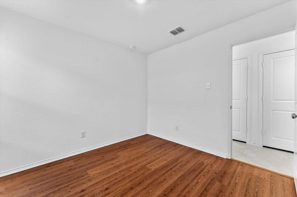211 Herman Lane Princeton, TX 75407 - Photo 18 of 40 a view of empty room with wooden floor